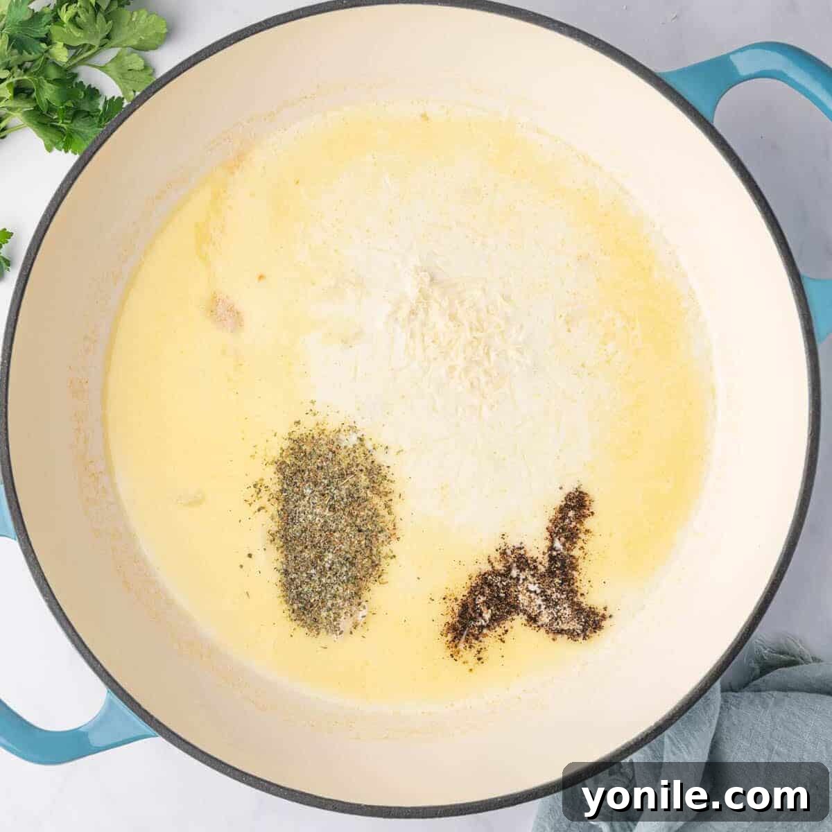 Seasoning the cream sauce for ravioli.