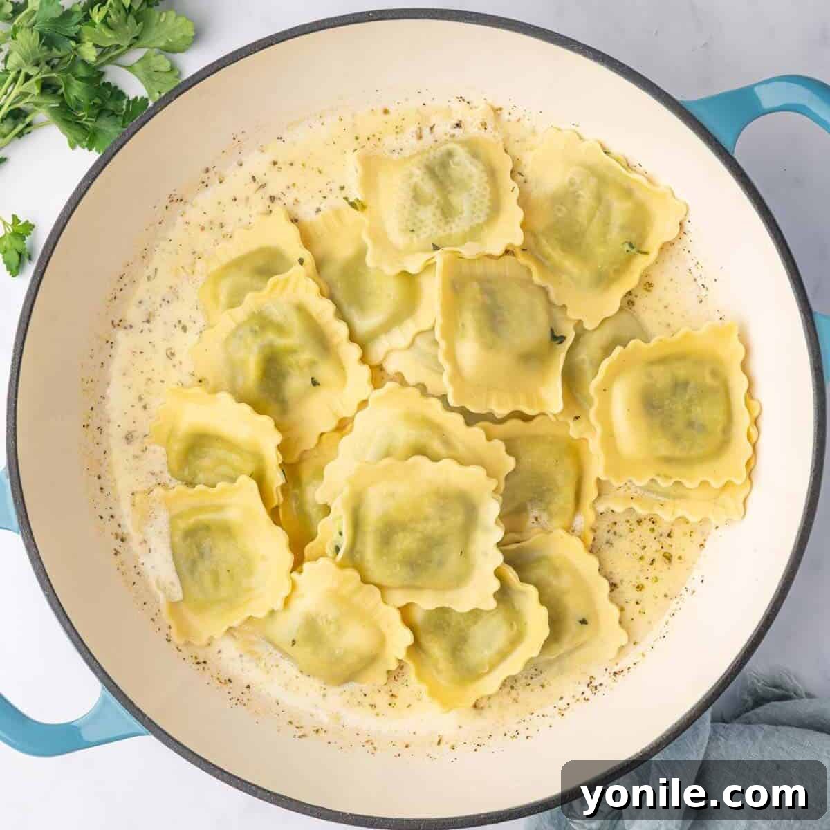 Add cooked ravioli to the cream sauce.