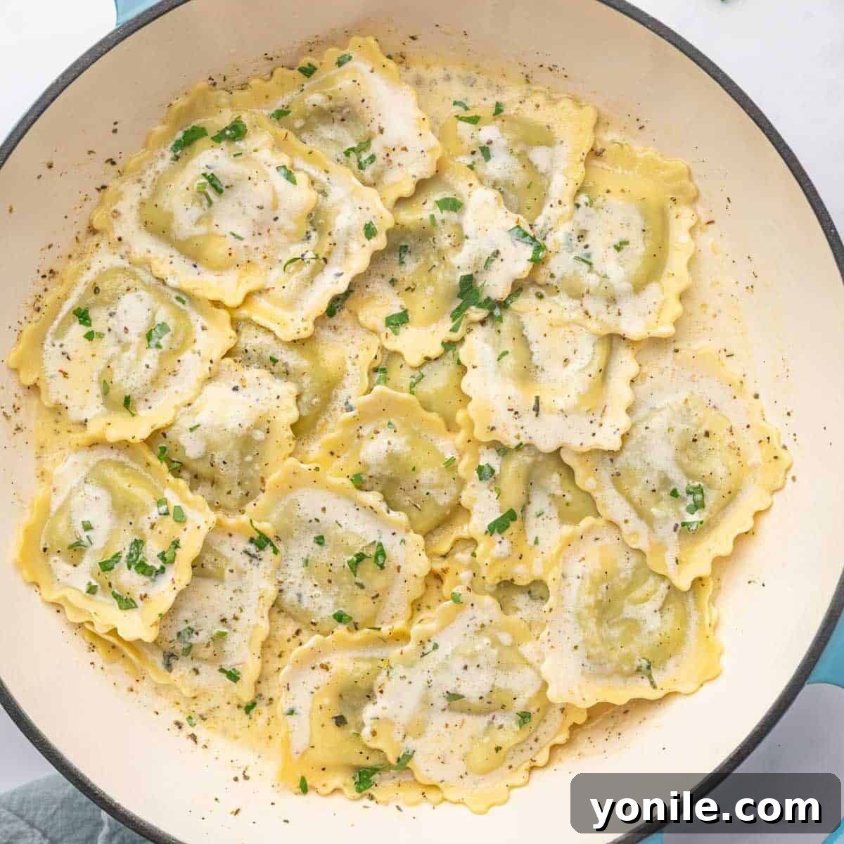 A dutch oven with spinach and cheese ravioli.
