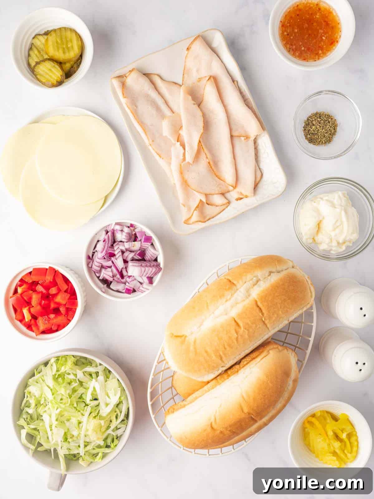 Zesty Chopped Italian Hero 3 Ingredients needed for a chopped deli sandwich laid out on a cutting board.