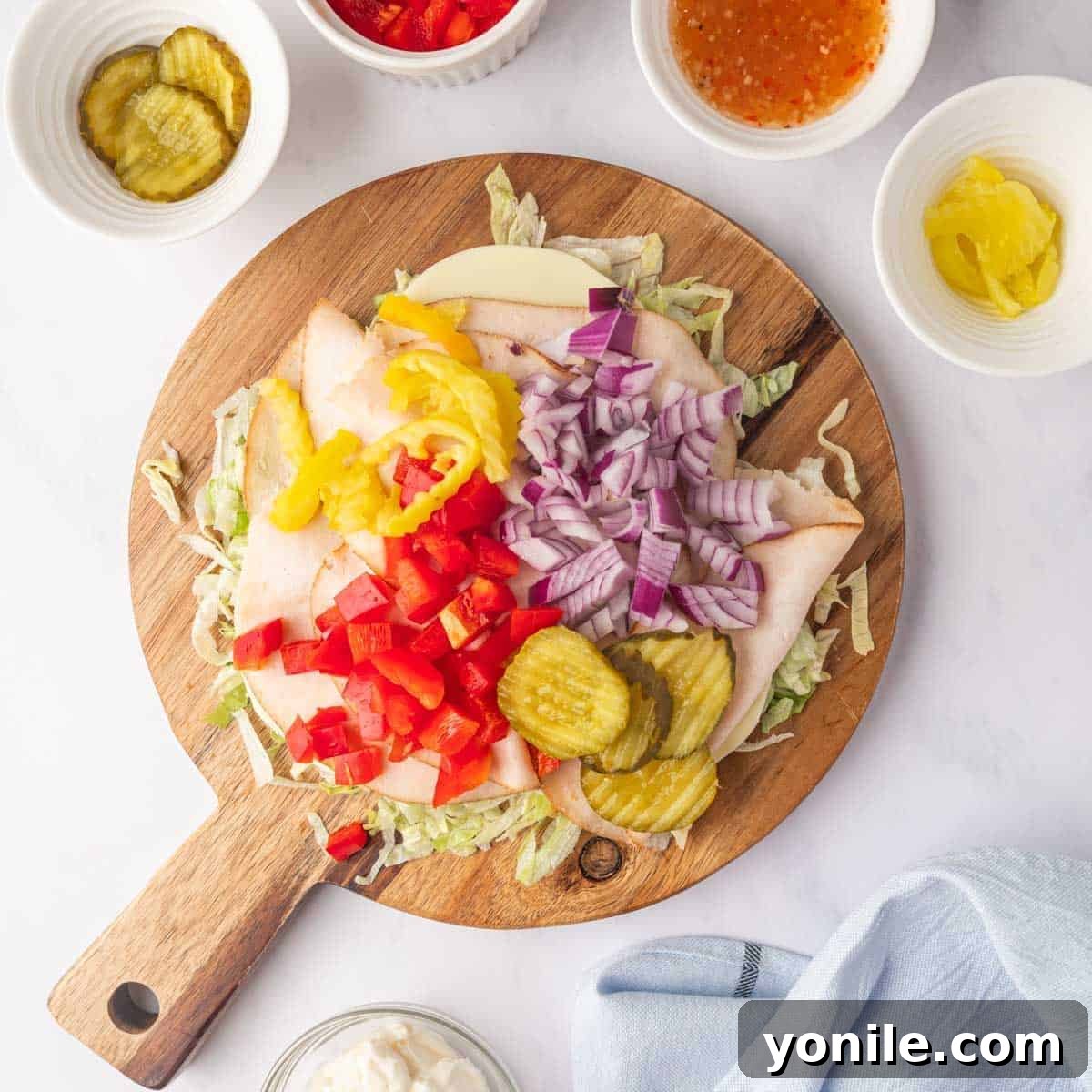 Zesty Chopped Italian Hero 4 All sandwich ingredients laid out on a large cutting board before being chopped.