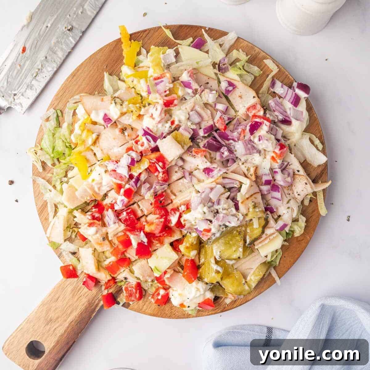 Zesty Chopped Italian Hero 6 All ingredients being chopped together on a platter for a uniform sandwich filling.