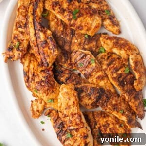 Grilled peri peri chicken on a platter.