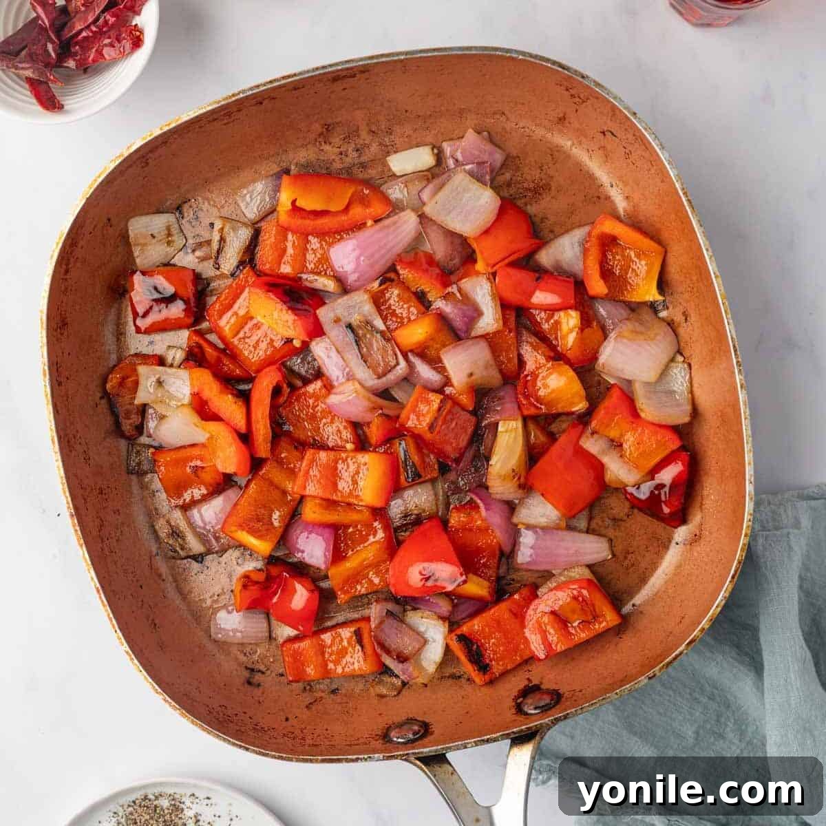 Onions and bell peppers are sauteed until tender.