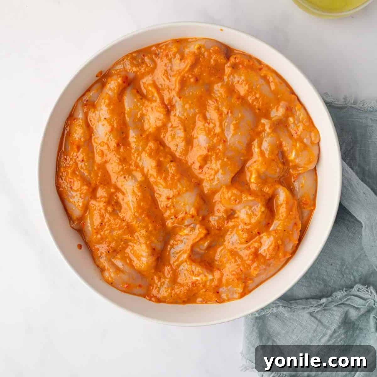 Chicken marinating in peri peri sauce.