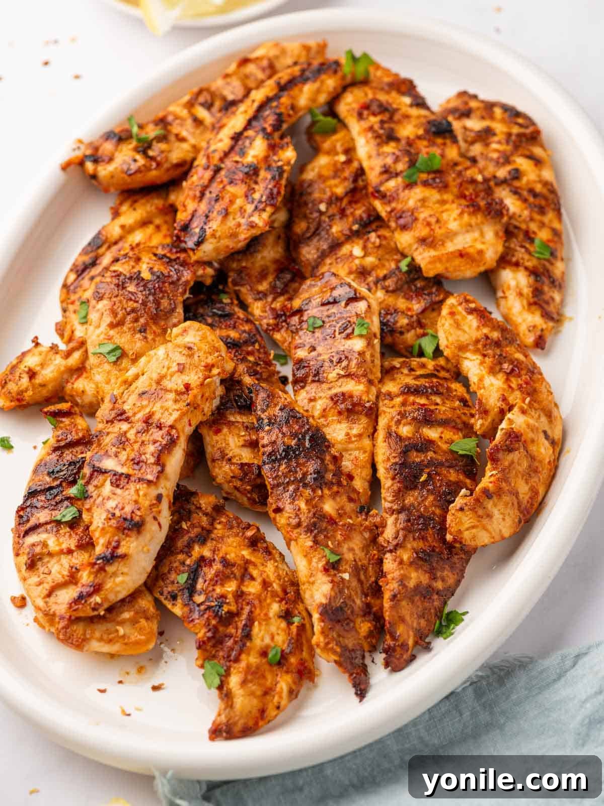 A pile of spicy chicken tenders on a plate.