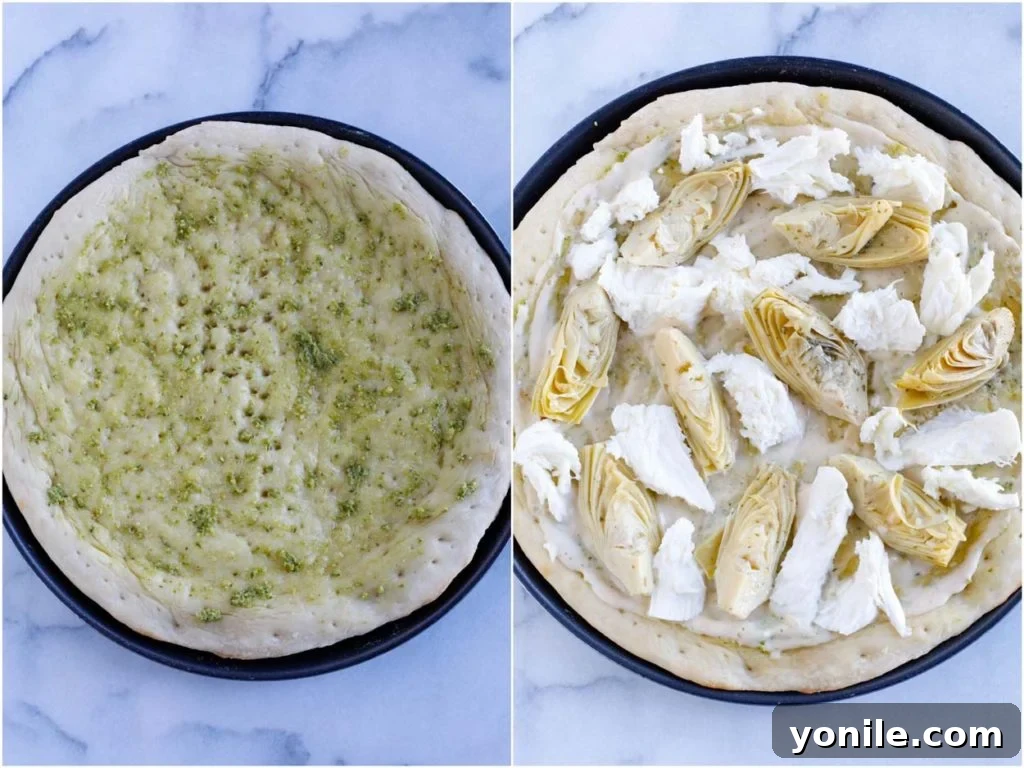 Adding quartered artichoke hearts to a partially baked pizza base.