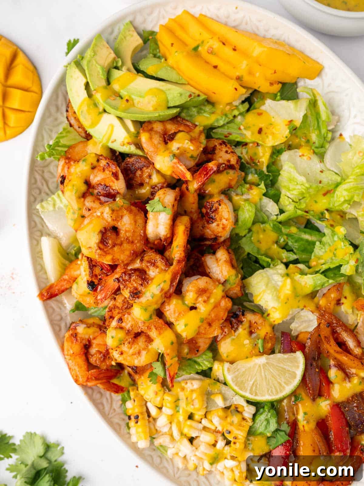 Close-up view of Mango Shrimp Salad, showcasing the arrangement of shrimp, mango, and vegetables on a platter.