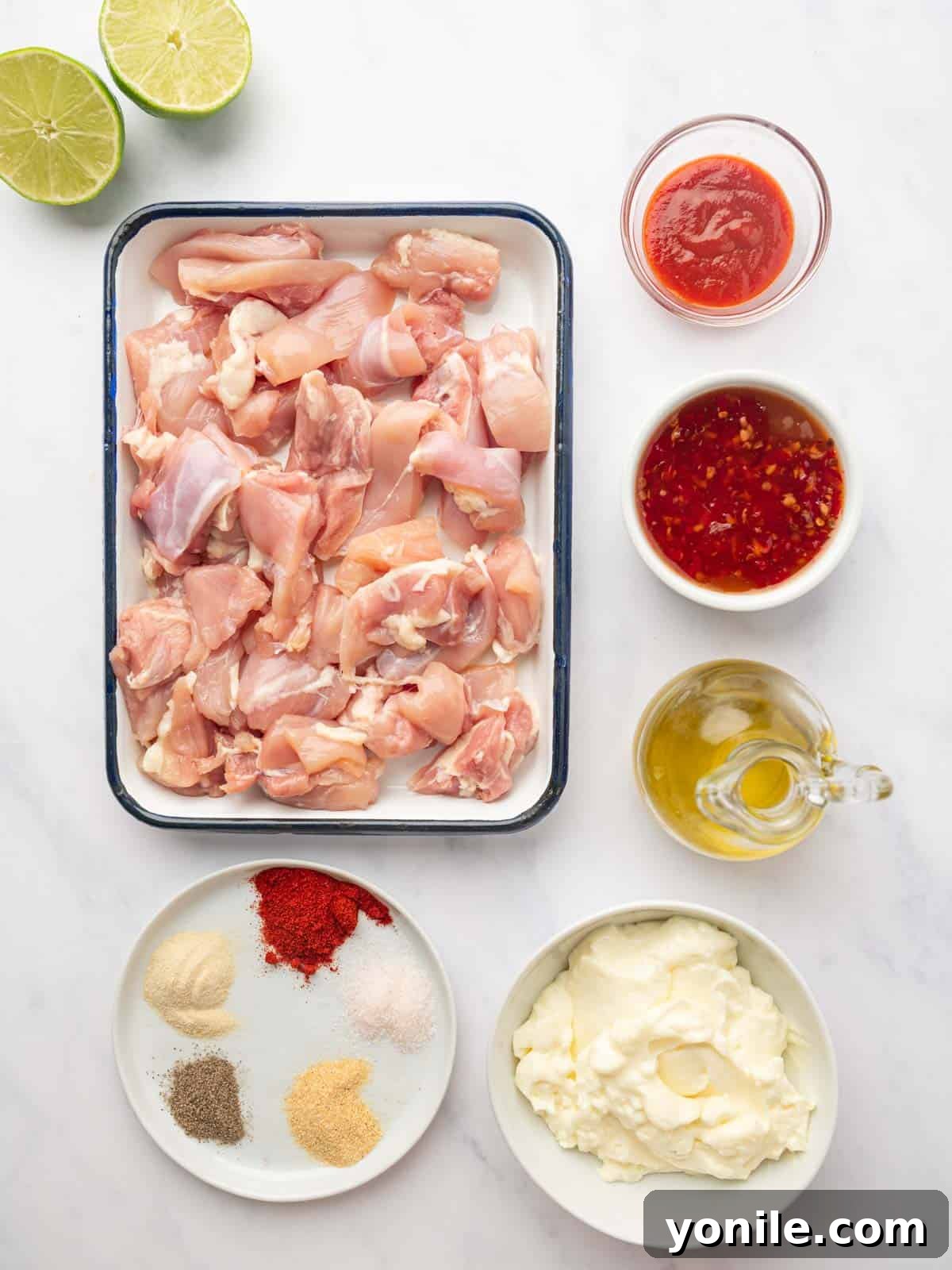 All the fresh ingredients meticulously laid out for preparing Bang Bang Chicken Skewers.
