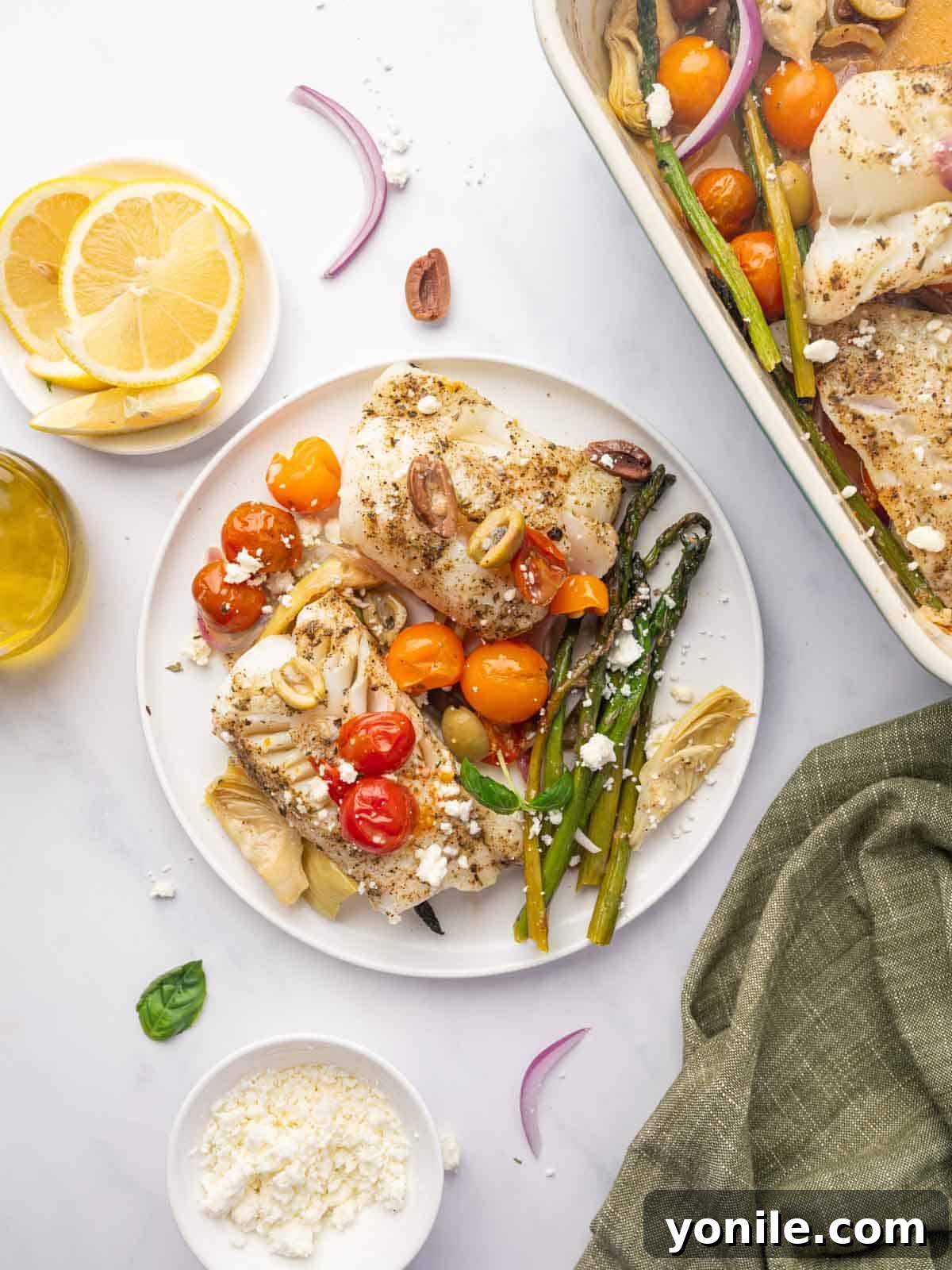 Sun-Kissed Mediterranean Cod 10 A plate of Mediterranean cod fillets served with a colorful assortment of roasted vegetables.