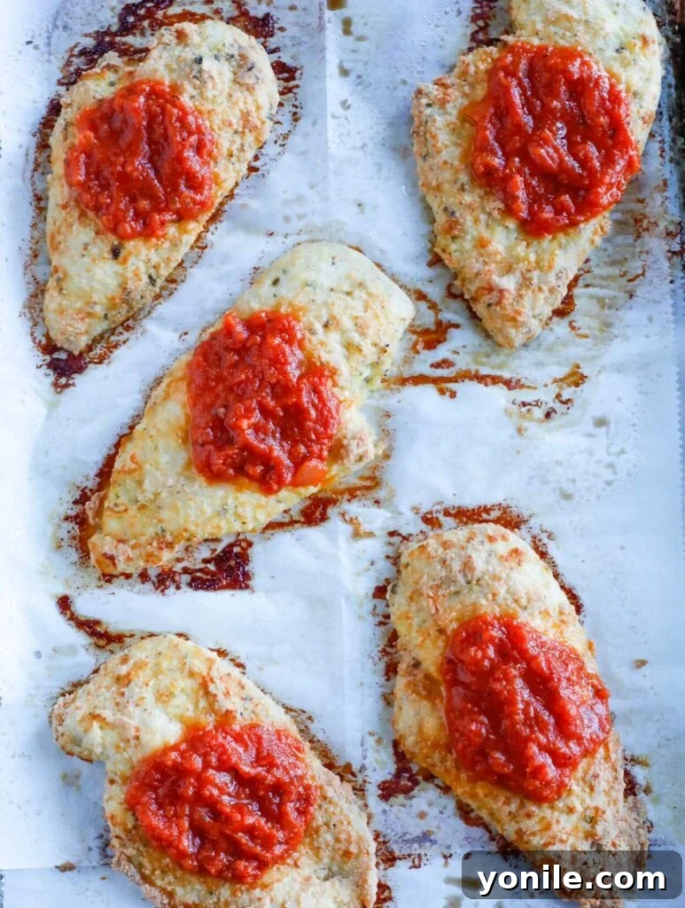 top down shot of baked chicken parm on tray