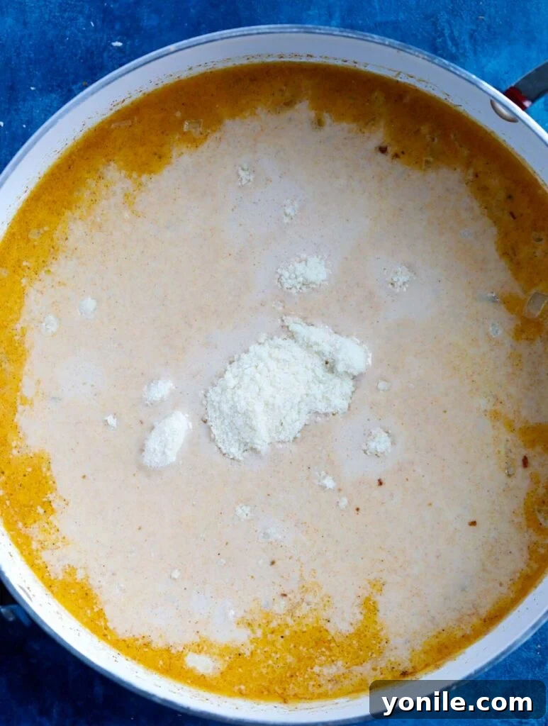 creamy cajun sauce simmering in a pot.