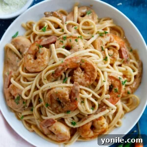 Creamy Shrimp Cajun Pasta, a close-up shot of the dish with a fork twirled in pasta.