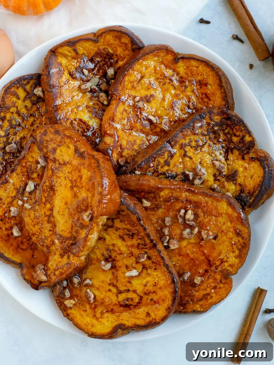 Pumpkin Spice French Toast: A Delicious Fall Breakfast Delightful pumpkin French toast topped with maple syrup and crushed pecans, ready to be enjoyed as a festive fall breakfast.