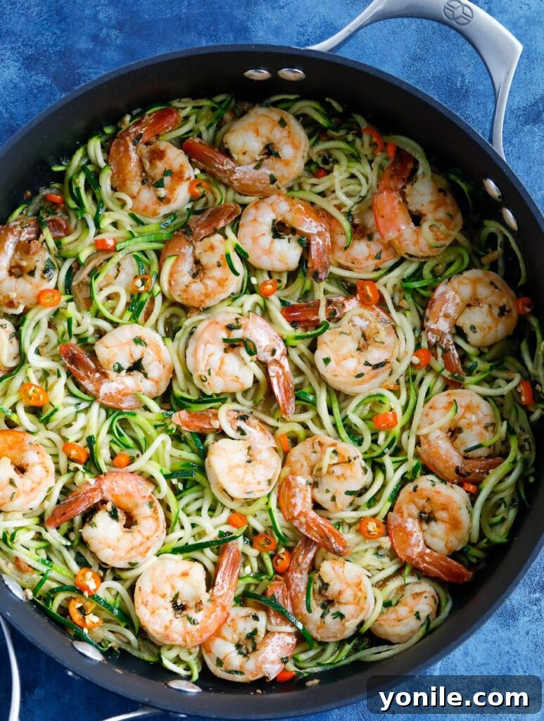 Garlic Shrimp Zoodles Zucchini Noodles with Shrimp in a skillet, garnished with fresh parsley