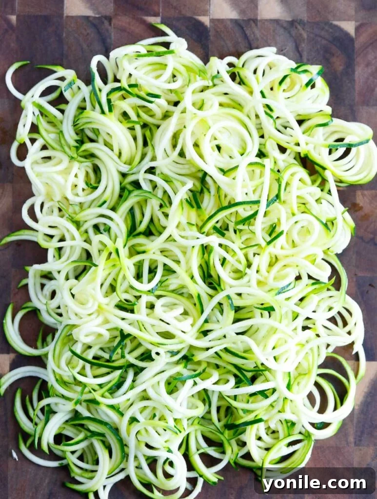 zucchini Freshly spiralized zucchini noodles (zoodles) on a cutting board