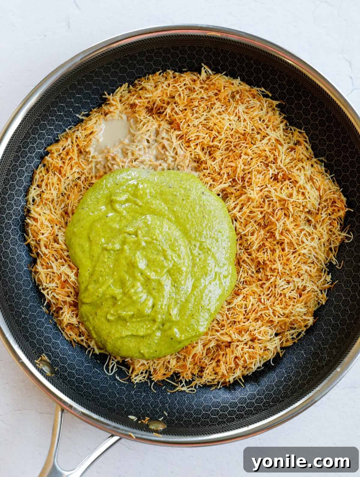 Dubai Strawberry Chocolate Delight 4 Mixing pistachio cream and tahini into the perfectly toasted kataifi dough in a pan, creating the crispy, flavorful base for the cups.