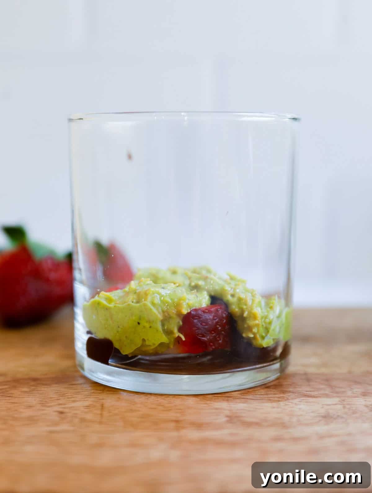 Dubai Strawberry Chocolate Delight 7 The process of layering the Dubai Strawberry Cup, with a base of kataifi and pistachio, followed by chocolate, and topped with fresh strawberries, ready for another layer.