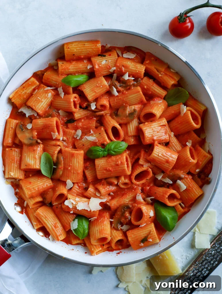 Creamy Red Pepper Pasta in a skillet, showcasing a vibrant orange sauce and rigatoni