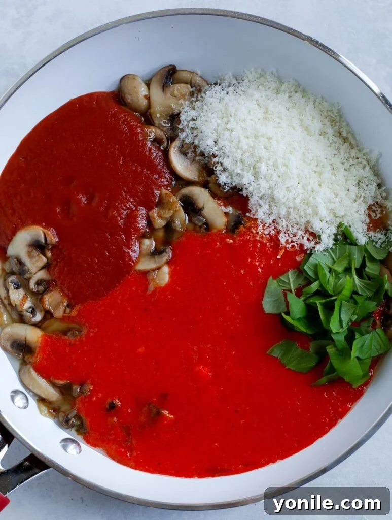 Vibrant red pepper pasta sauce simmering in a pan