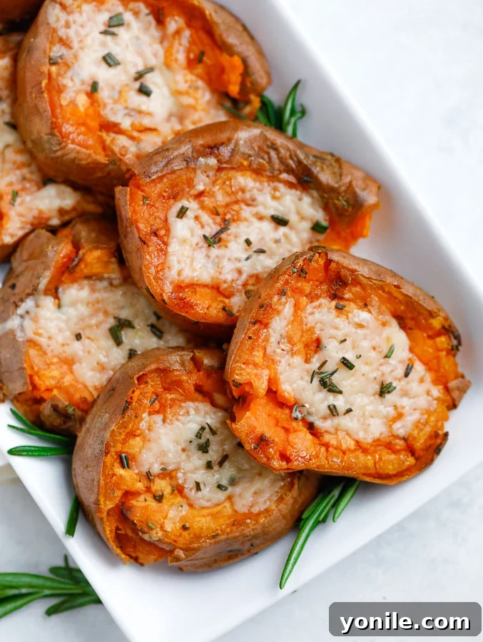 Regular Potatoes with Herbs and Garlic Close-up of roasted regular potatoes with herbs and garlic on a white serving dish.