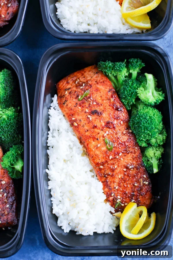 A meal prep box with spicy honey garlic salmon, rice, and broccoli.