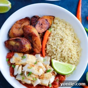 Caribbean Jerk Fish, quinoa, tomato sauce, and fried plantains topped with chilies