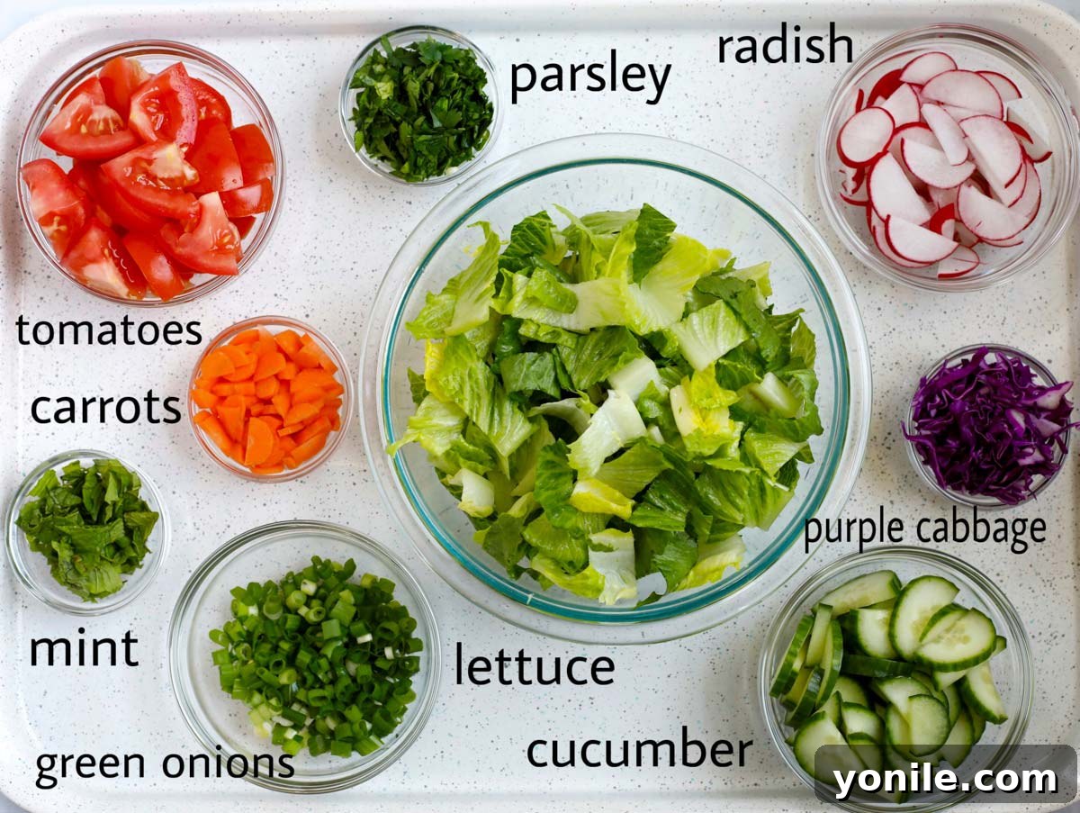 Vibrant Lebanese Fattoush 3 A colorful array of fresh ingredients for Fattoush salad, including pita bread, tomatoes, cucumbers, and herbs.