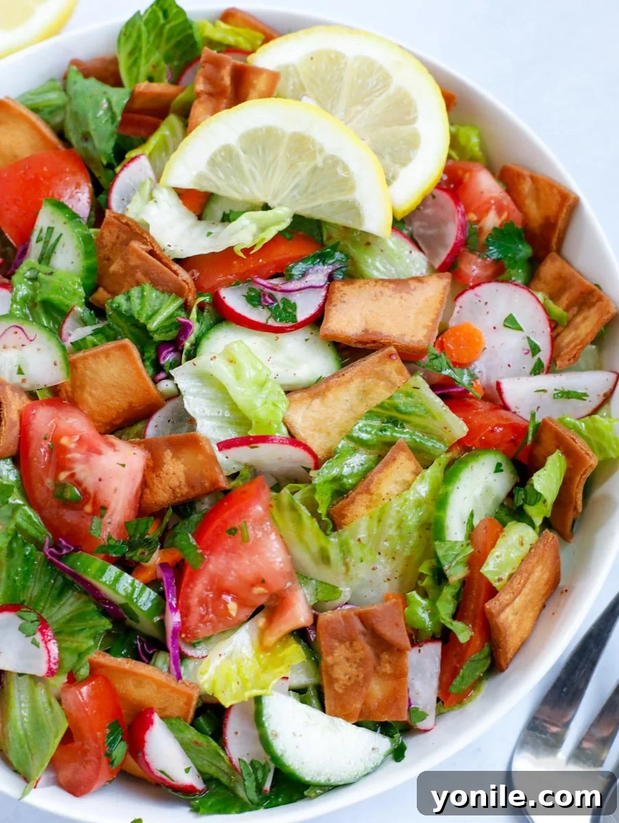 Vibrant Lebanese Fattoush 7 Close-up view of a freshly made Fattoush salad in a bowl, showcasing its crisp texture and rich colors.