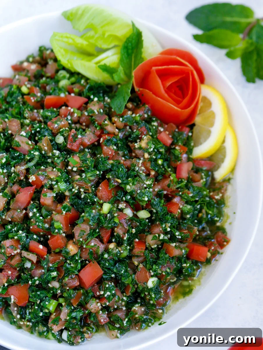 Lebanese tabbouleh salad garnished with sliced lemons and fresh vegetables