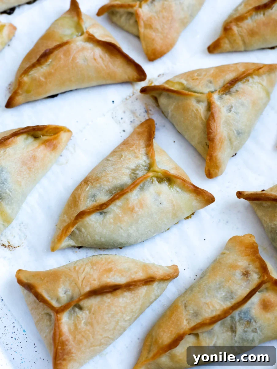 Traditional Lebanese Spinach Pies 15 baked spinach pie on a sheet pan