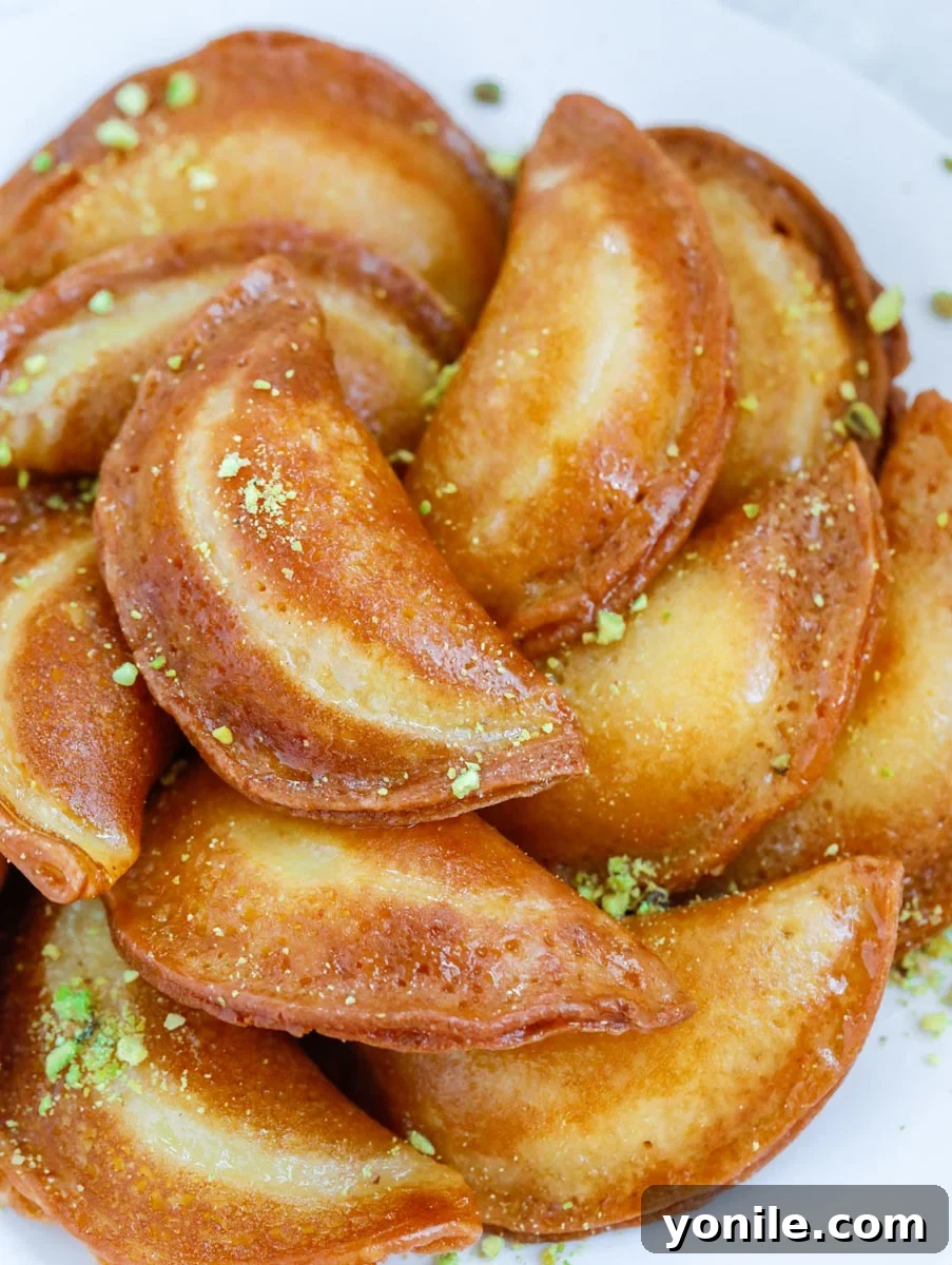 fried atayef garnished with ground pistachios