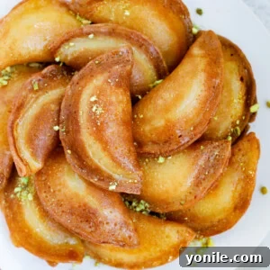 Fried atayef garnished with ground pistashios