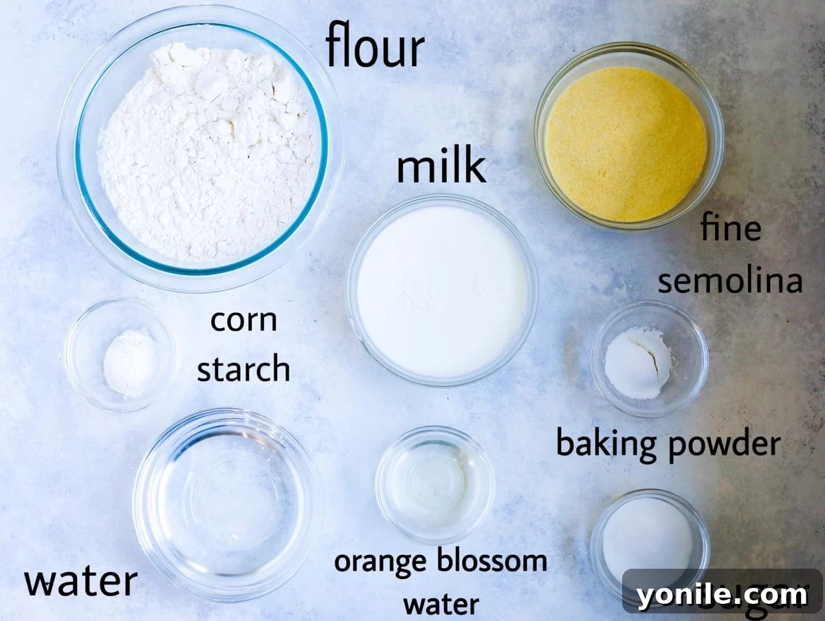 Atayef pancake ingredients laid out on a table. flour, milk, fine semolina, corn starch (optional) baking powder, sugar, water and orange blossom water.