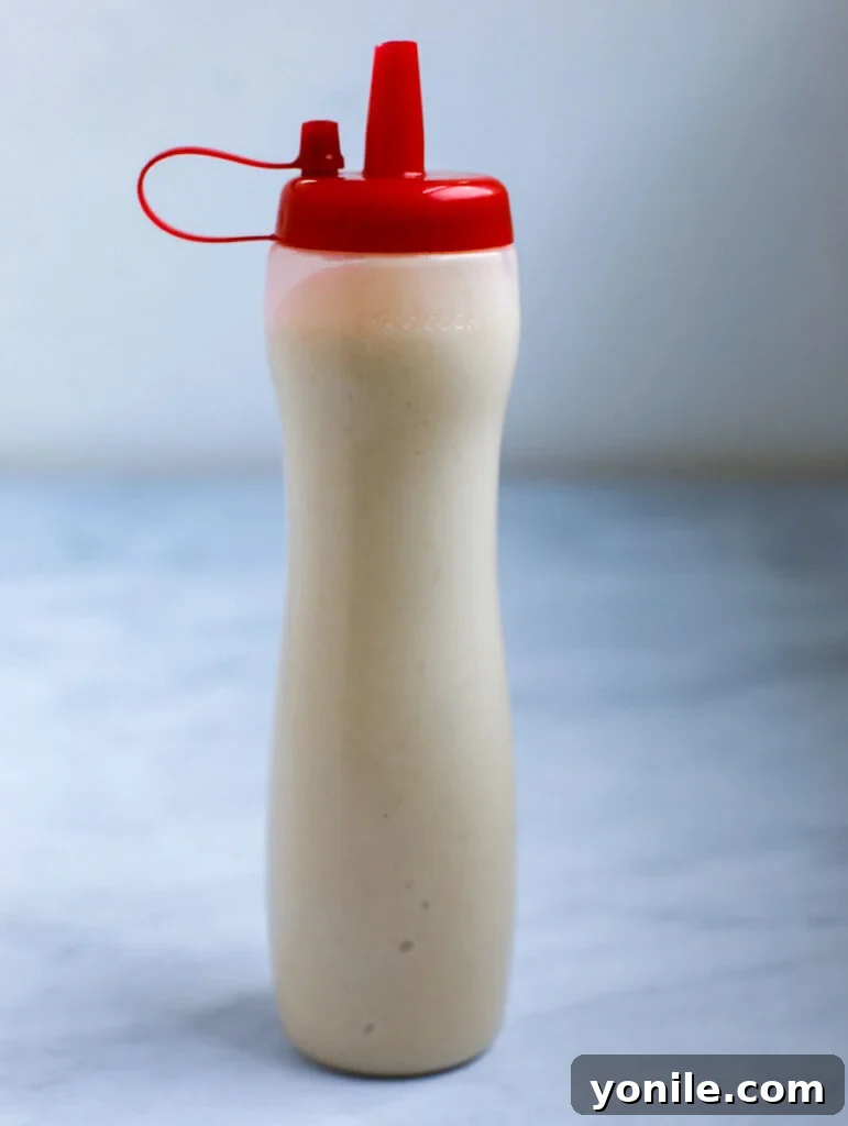 Pancake batter stored in a squeezable condiment bottle, ready for precise pouring.