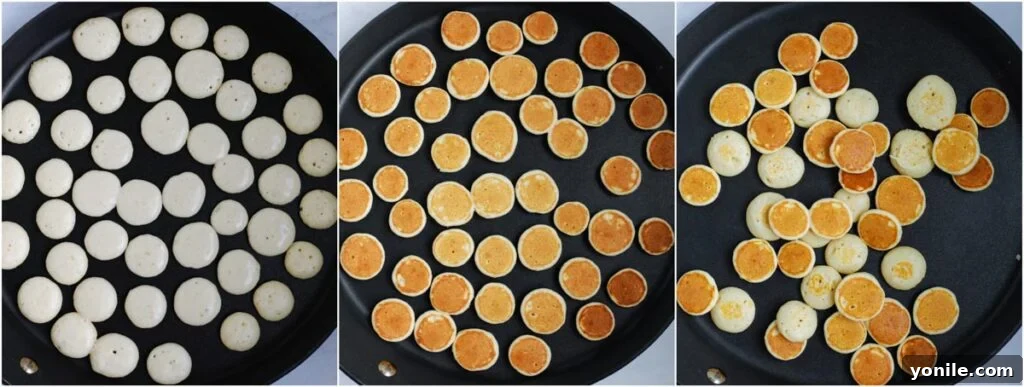 Numerous small pancake cereal dots cooking on a non-stick pan, forming perfect miniature shapes.