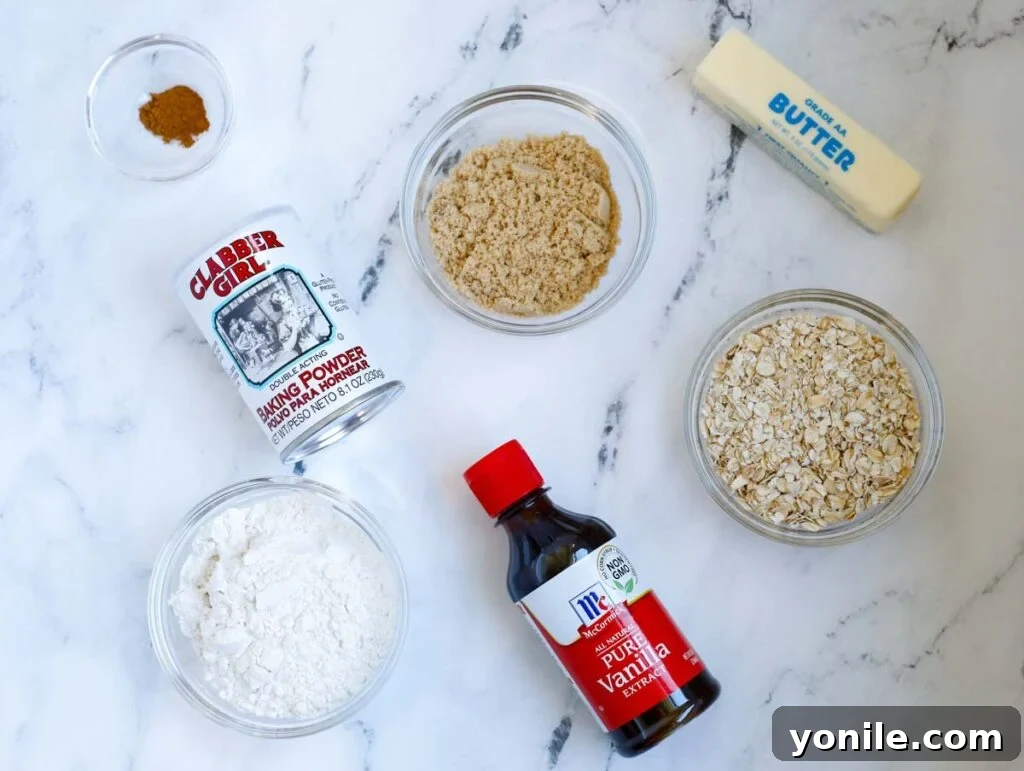 Crisp topping ingredients laid out: rolled oats, all-purpose flour, soft butter, light brown sugar, baking powder, and ground cinnamon.
