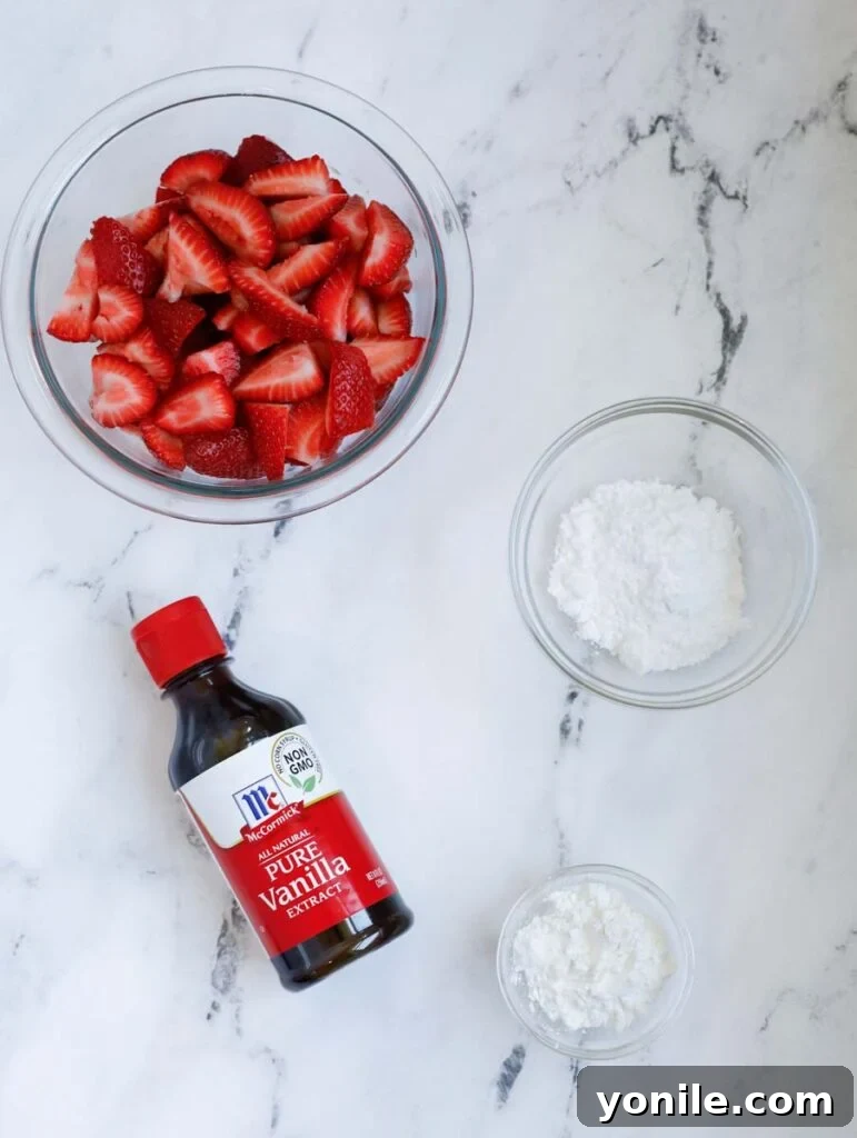 Strawberry crisp filling ingredients: fresh hulled strawberries, vanilla extract, confectioner's sugar, and corn starch, beautifully arranged.