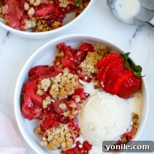 Strawberry Crisp served in a bowl with a scoop of ice cream