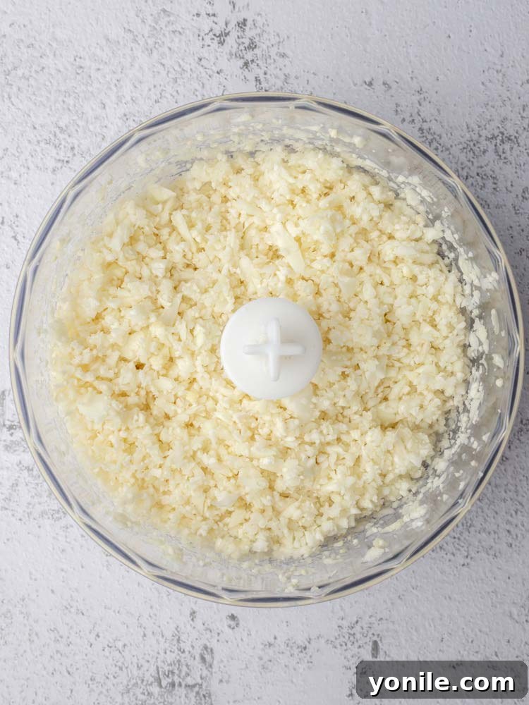 Finely riced cauliflower in a food processor after pulsing