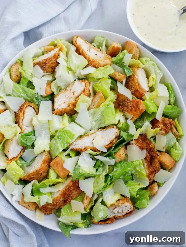 top down shot of crispy chicken salad with chicken, croutons, and Parmesan