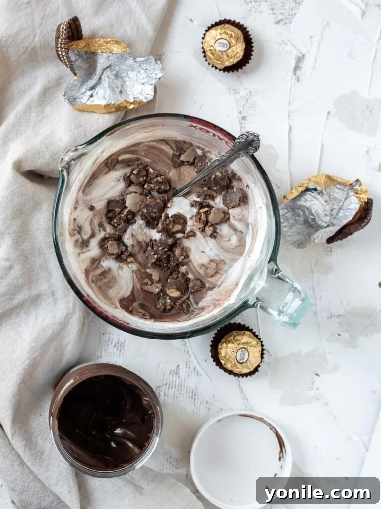 Nutella Swirl Indulgence 4 A bowl containing a mixture of Nutella and sweetened condensed milk, with a separate bowl of freshly whipped heavy cream, ready to be combined.