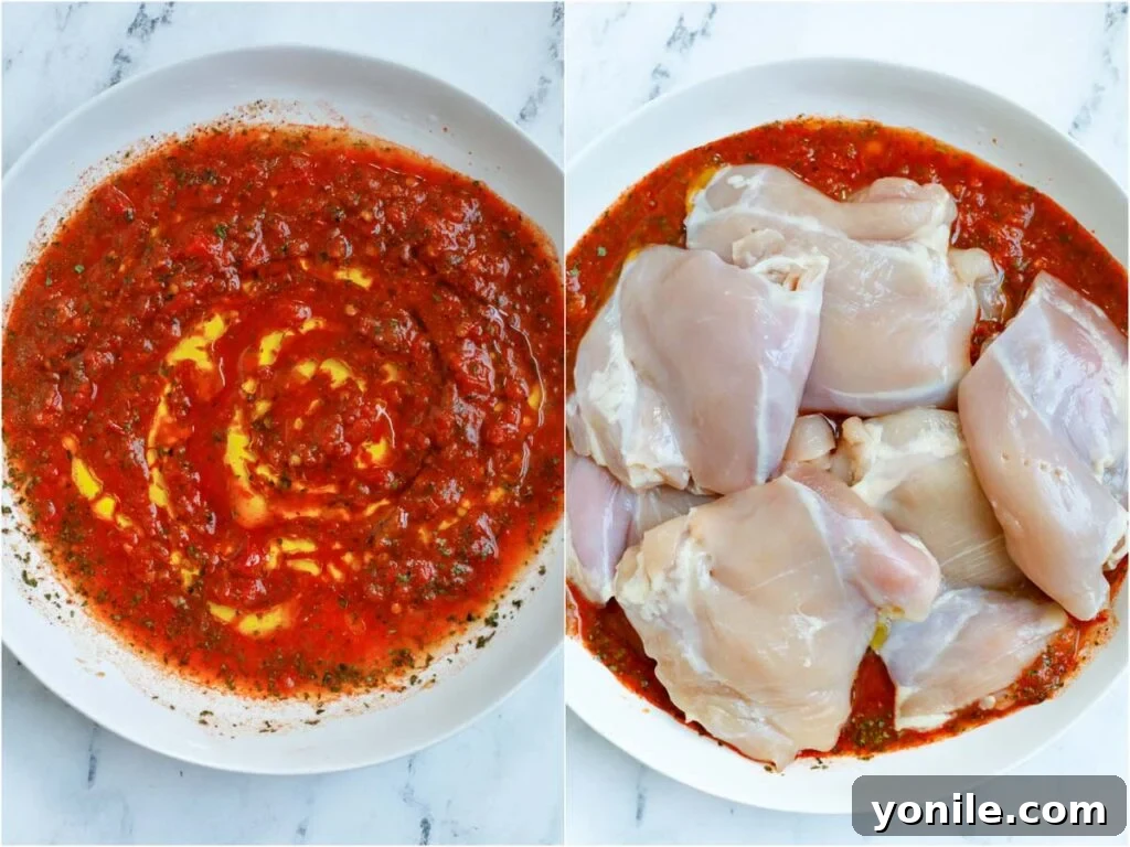 Harissa-Infused Grilled Chicken Thighs 4 Boneless chicken thighs soaking in a rich, red harissa marinade in a glass bowl.