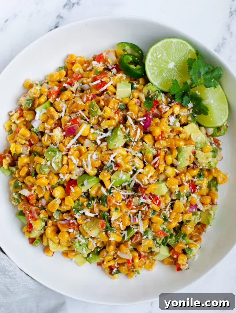 Vibrant top-down view of Mexican street corn salad in a bowl, garnished with fresh cilantro and cotija cheese