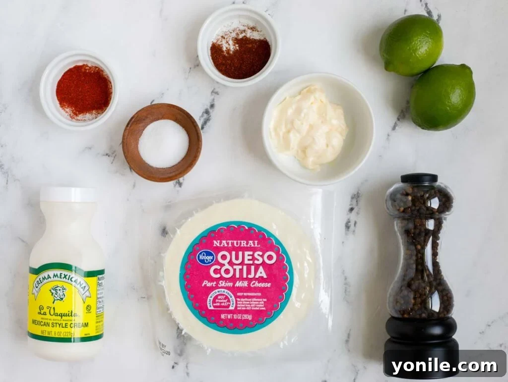 Ingredients for the creamy Mexican street corn salad dressing: mayo, limes, Mexican cream, spices, cotija cheese, and olive oil.