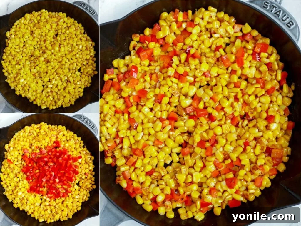 Corn and bell peppers being cooked in a skillet, getting a light char for the street corn salad.