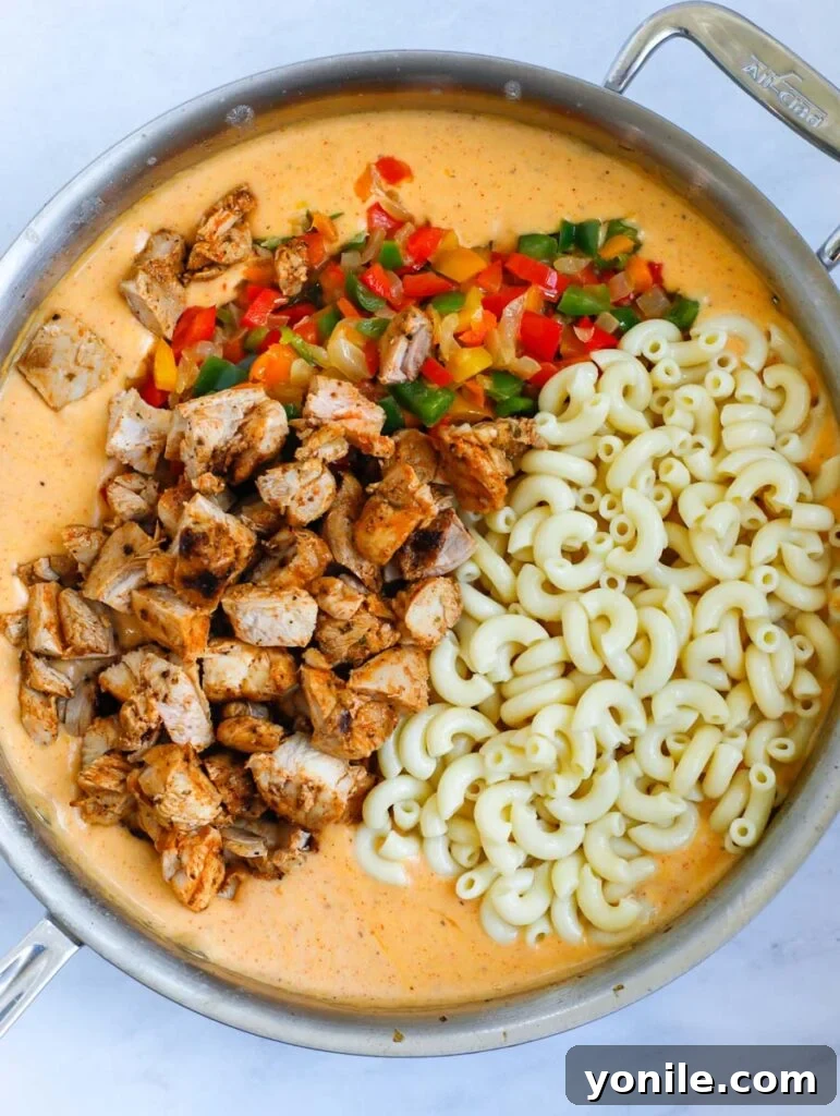 Sizzling Fajita Macaroni 7 Combining cooked pasta, chicken, and vegetables with the cheese sauce