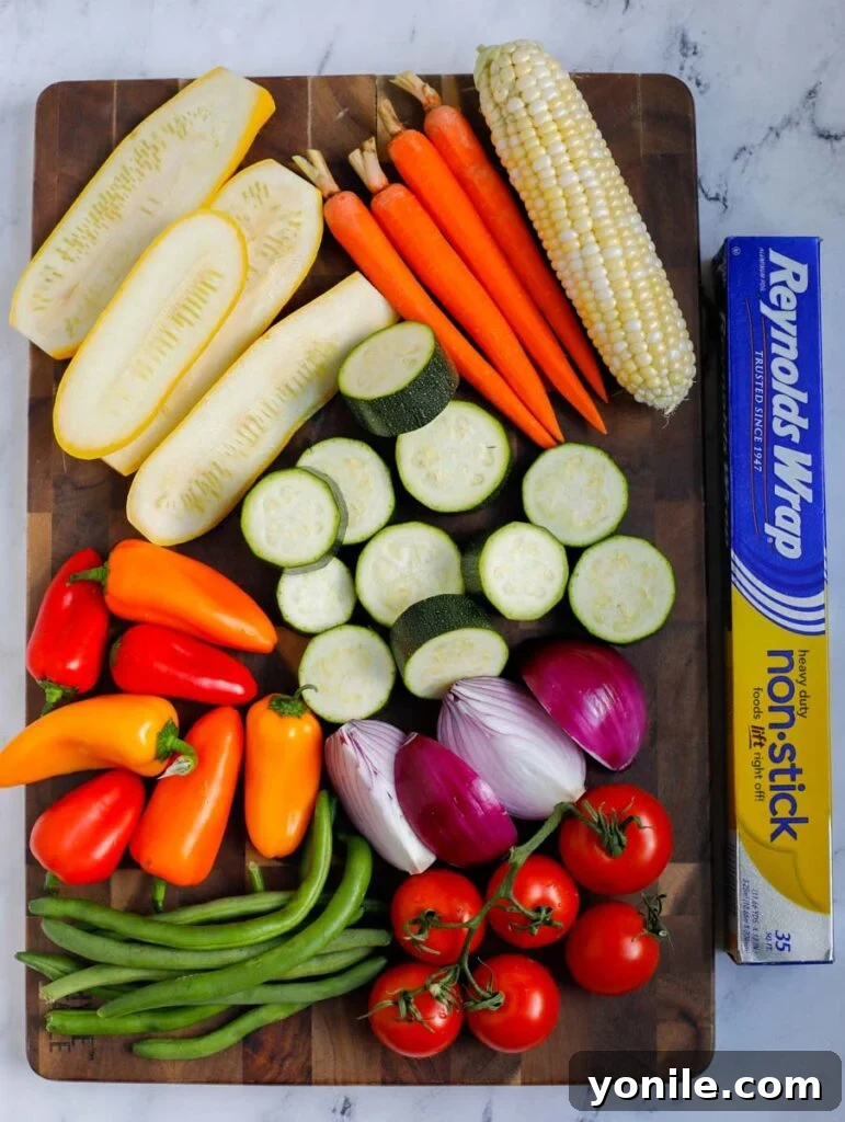 Grilled Garden Goodness 3 Ingredients laid out for Best Grilled Vegetables including zucchini, squash, peppers, corn, and seasonings
