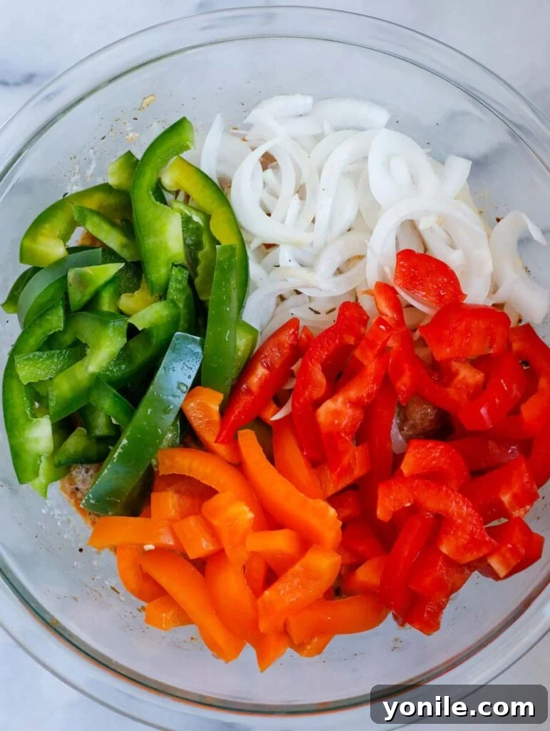 Freshly sliced bell peppers and onions, ready for the Chicken Fajita Bake, displaying vibrant colors.