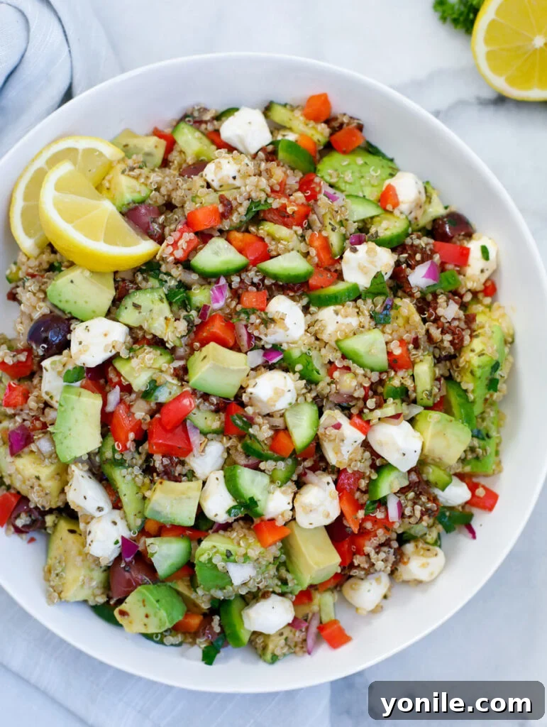 Vibrant Mediterranean Quinoa Salad 2 Easy Mediterranean Quinoa Salad in a white bowl, showcasing its fresh ingredients and vibrant colors.
